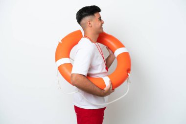 Young handsome man isolated on white background with lifeguard equipment and with happy expression