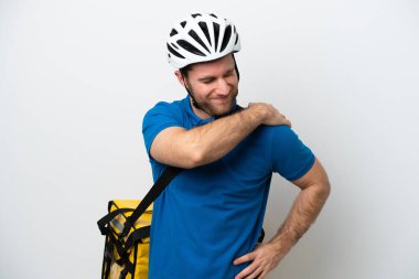 Young caucasian man with thermal backpack isolated on white background suffering from pain in shoulder for having made an effort