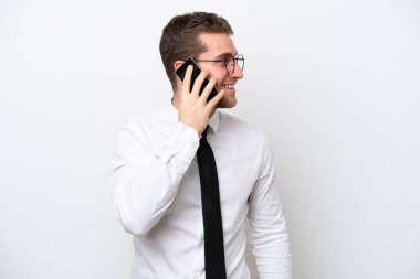 Young business caucasian man isolated on white background keeping a conversation with the mobile phone with someone