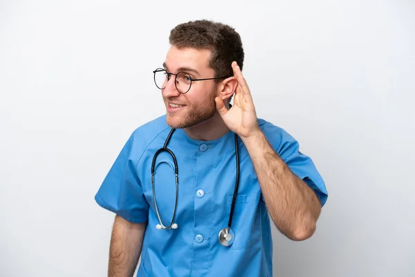 Young Surgeon Doctor Caucasian Man Isolated White Background Listening Something — Stockfoto