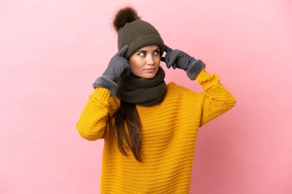 Young Caucasian Girl Winter Hat Isolated Pink Background Having Doubts — Stock Photo, Image