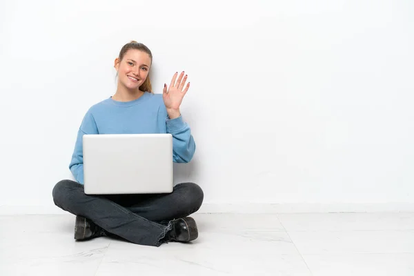 Junge Frau Mit Laptop Sitzt Auf Dem Boden Und Grüßt — Stockfoto