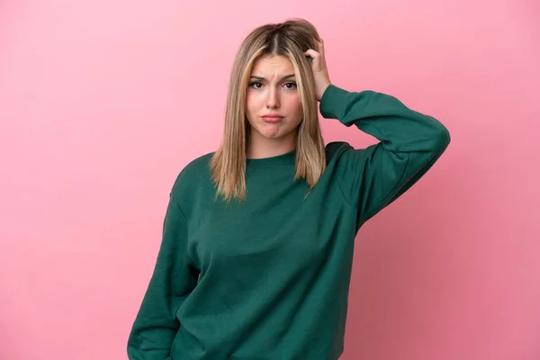 Young caucasian woman isolated on pink background with an expression of frustration and not understanding