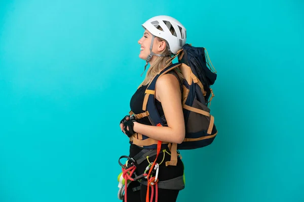 Young Caucasian Rock Climber Woman Isolated Blue Background Laughing Lateral — Stock Photo, Image