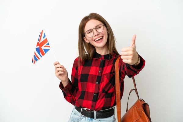 年轻女子举着英国国旗 蓝色背景 大拇指竖起 因为发生了一些好事 — 图库照片