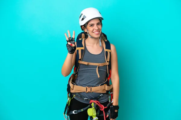 Young Italian rock-climber woman isolated on blue background happy and counting three with fingers