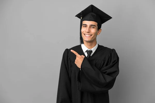 Young Argentinian University Graduate Isolated Grey Background Pointing Side Present — Stock Photo, Image