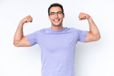 Beyaz arka planda izole genç beyaz adam güçlü jest yapıyor.