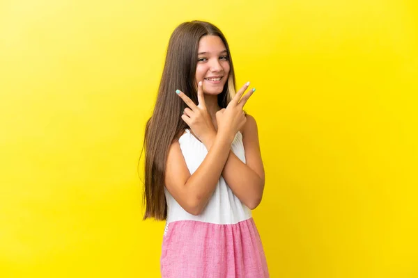 Little Caucasian Girl Isolated Yellow Background Smiling Showing Victory Sign — Stock Photo, Image