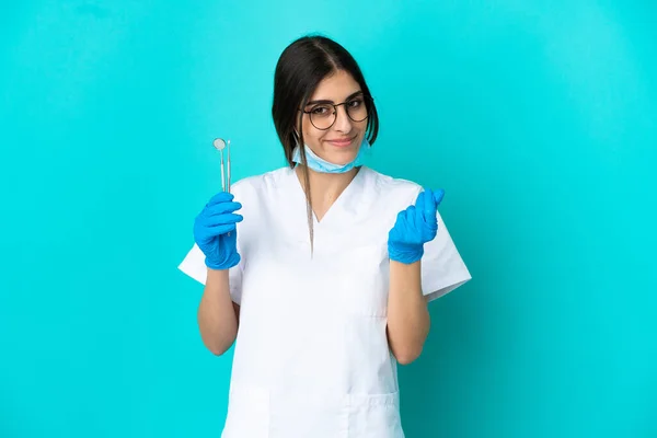 Young Caucasian Dentist Woman Holding Tools Isolated Blue Background Making — Stockfoto