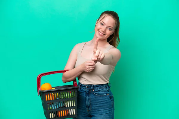 Young Woman Holding Shopping Basket Full Food Isolated Green Background — Stock Photo, Image