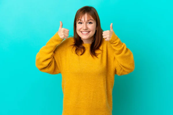 Redhead Girl Isolated Blue Background Giving Thumbs Gesture — Stockfoto