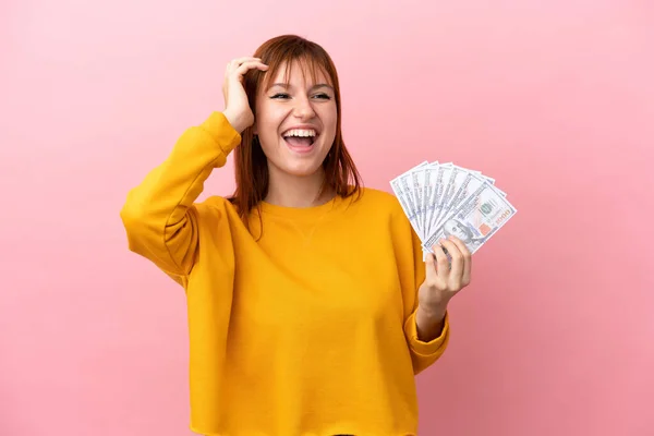 Redhead Girl Taking Lot Money Isolated Pink Background Smiling Lot — Stock fotografie