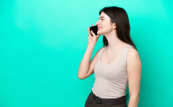 Young Russian Woman Isolated Green Background Keeping Conversation Mobile Phone — Zdjęcie stockowe