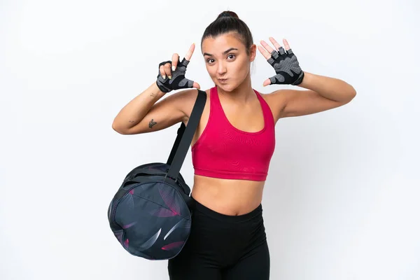 Young sport woman with sport bag isolated on white background counting seven with fingers