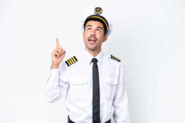 Airplane pilot over isolated white background pointing up and surprised