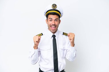 Airplane pilot over isolated white background celebrating a victory in winner position
