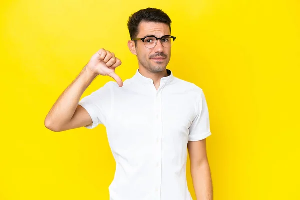 Young Handsome Man Isolated Yellow Background Showing Thumb Negative Expression — Stock Photo, Image