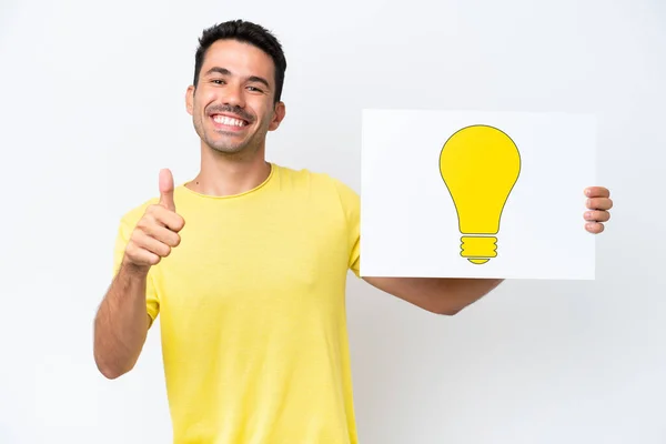 Young Handsome Man Isolated White Background Holding Placard Bulb Icon — Stock Photo, Image