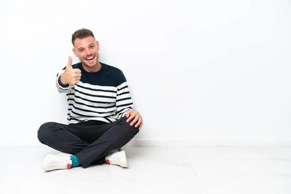 Young Man Sitting Floor Isolated White Background Thumbs Because Something — Stock fotografie