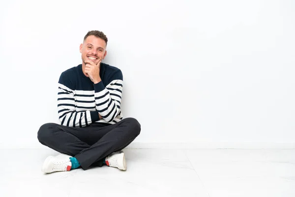 Young Man Sitting Floor Isolated White Background Smiling — Stock fotografie