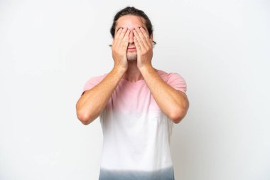 Caucasian handsome man isolated on white background covering eyes by hands