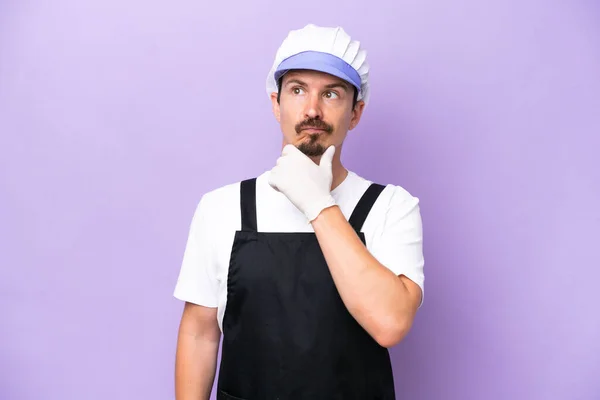 Fishmonger Man Wearing Apron Isolated Purple Background Having Doubts — Zdjęcie stockowe
