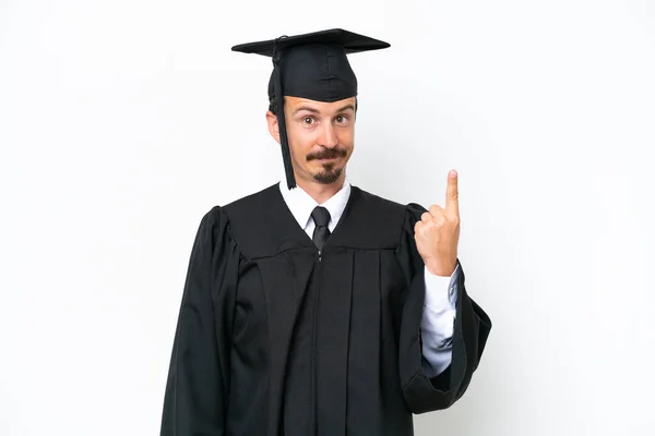 一个年轻的大学毕业生被孤立在白人背景下 用食指指点点着一个伟大的想法 — 图库照片