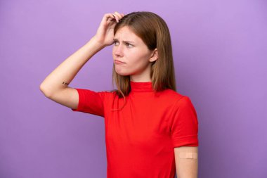 Mor arka planda izole edilmiş yara bandı takan genç bir İngiliz kadının şüpheleri ve kafa karıştırıcı bir yüz ifadesi var.