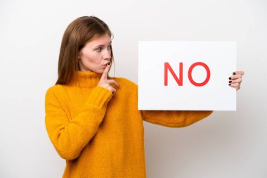 Young English woman isolated on white background holding a placard with text NO doing silence gesture