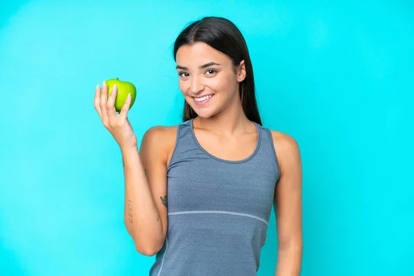 Giovane Donna Caucasica Isolata Sfondo Blu Con Una Mela — Foto Stock