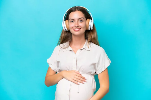 Young Caucasian Woman Isolated Blue Background Pregnant Listening Music — Φωτογραφία Αρχείου