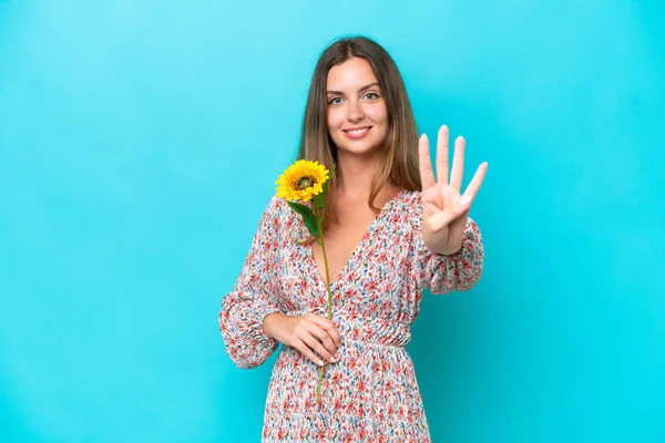 Young Caucasian Woman Holding Sunflower Isolated Blue Background Happy Counting — Stock Photo, Image