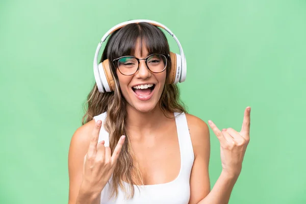 Young Caucasian Woman Isolated Background Listening Music Making Rock Gesture — Stock Photo, Image