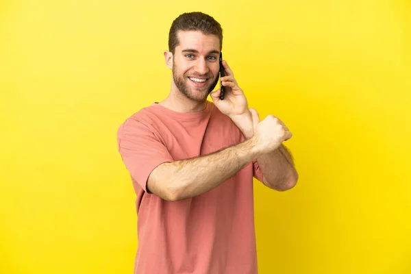 Handsome Blonde Man Using Mobile Phone Isolated Background Proud Self — Stock Photo, Image