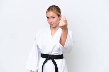Beyaz arka planda karate yapan beyaz bir kadın para hareketi yapıyor.