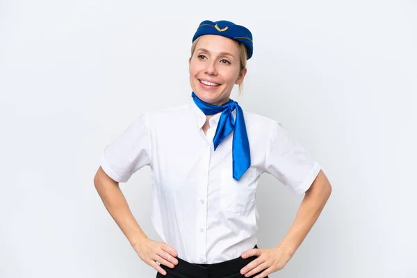 飛行機ブロンドスチュワーデス女性孤立した上にホワイト背景ポーズとともに腕でヒップと笑顔 — ストック写真