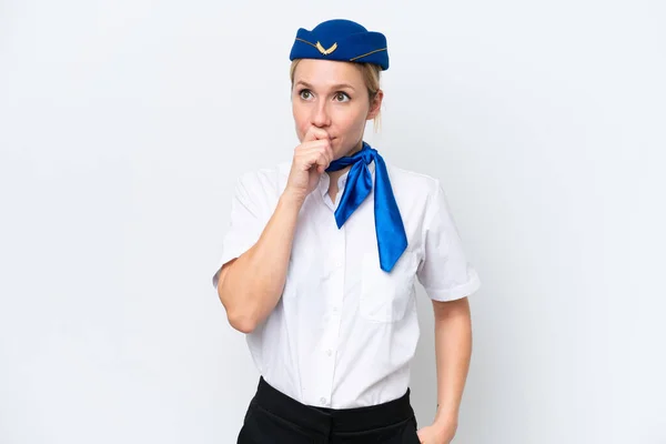 飛行機ブロンドスチュワーデス女性孤立した白い背景に疑問を持っていると混乱顔の表情 — ストック写真