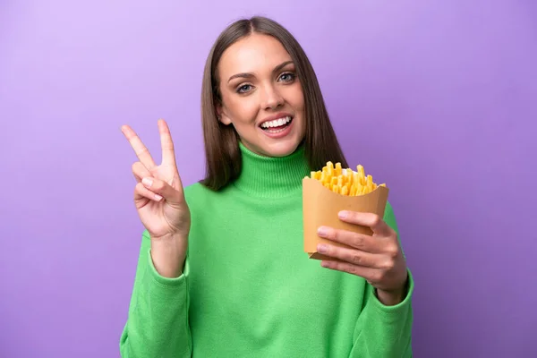 Young Caucasian Woman Holding Fried Chips Purple Background Smiling Showing — Stock Photo, Image