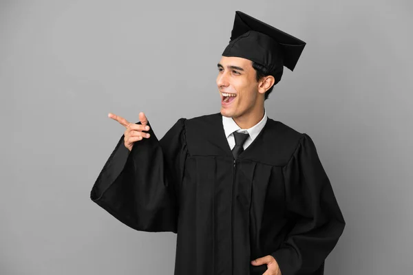 Young Argentinian University Graduate Isolated Grey Background Pointing Finger Side — Stock Fotó
