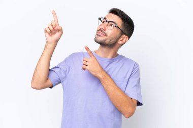 Young caucasian man isolated on white background pointing with the index finger a great idea