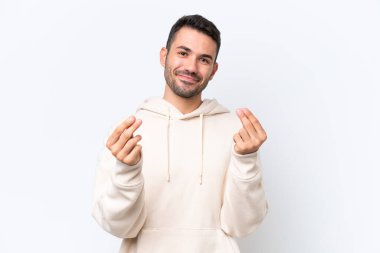 Beyaz arka planda izole genç beyaz adam para jesti yapıyor