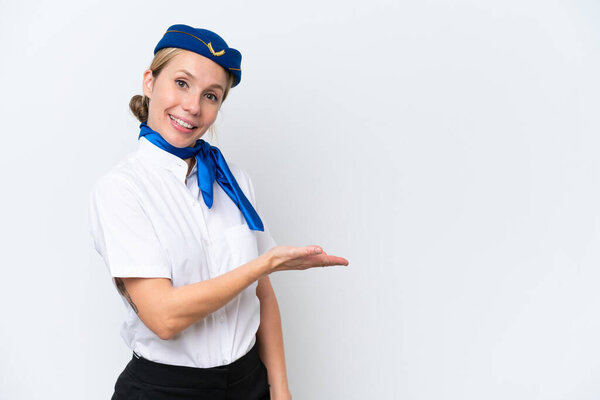 Airplane blonde stewardess woman isolated on white background presenting an idea while looking smiling towards
