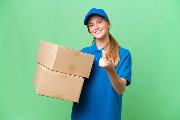 Delivery caucasian woman over isolated background making money gesture