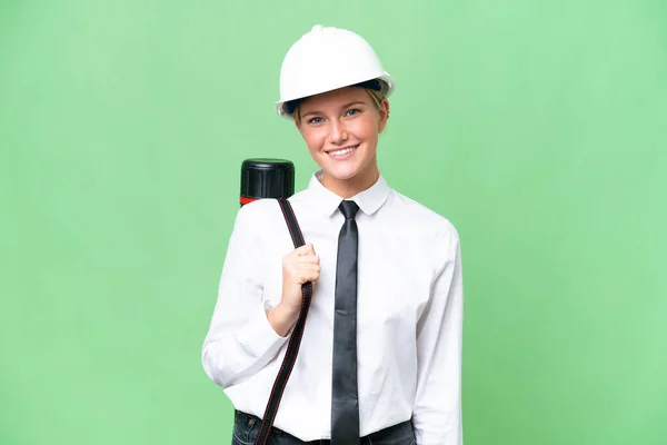 若い建築家の白人女性ヘルメットと保持設計図上の隔離された背景笑い — ストック写真