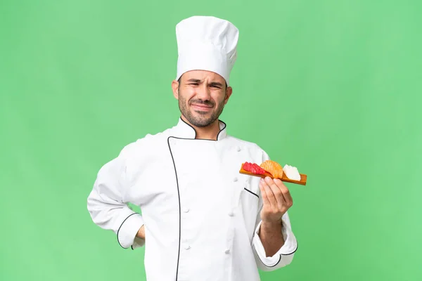 Young Caucasian Chef Holding Sushi Isolated Background Suffering Backache Having — Stock Photo, Image