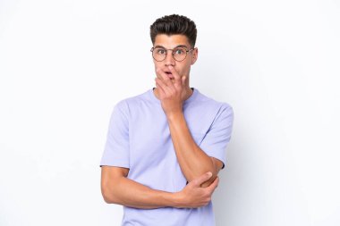 Beyaz arka planda izole genç beyaz adam şaşırdı ve şaşırdı