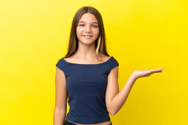 Pequeña Chica Caucásica Aislada Sobre Fondo Amarillo Sosteniendo Espacio Copia — Foto de Stock