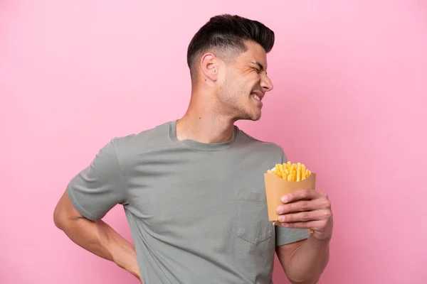 Ung Kaukasisk Man Som Håller Stekta Chips Isolerade Rosa Bakgrund — Stockfoto