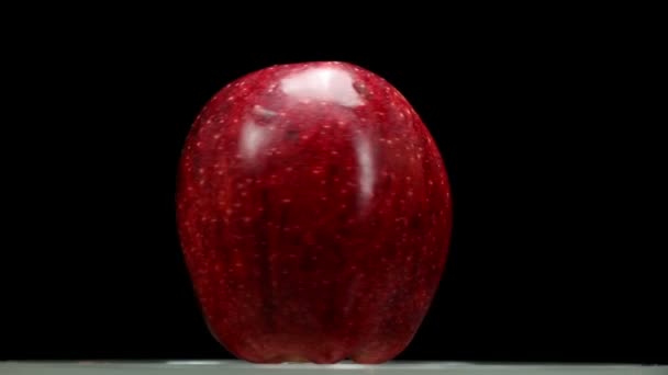 Super 35mm camera - Beautiful red apple turning against black background — Stock Video